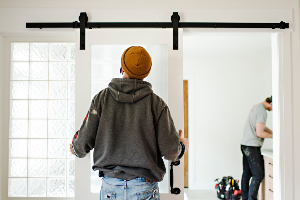 Contractor adjusting a sliding barn door